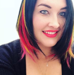 Dr. Emma Beckett with colored hair extensions